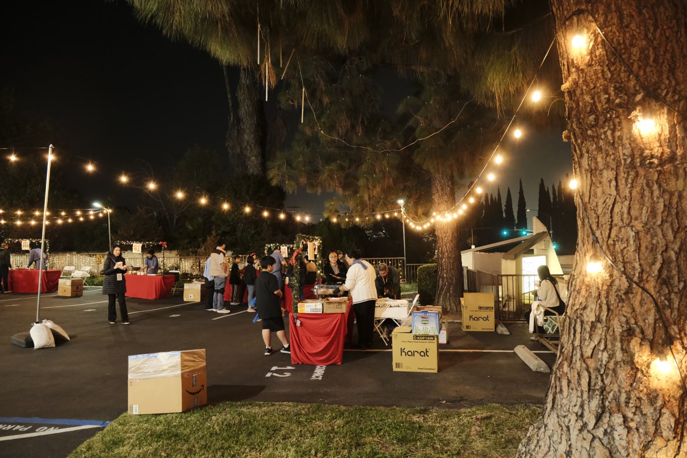 The night market in the parking lot, hung with string lights
