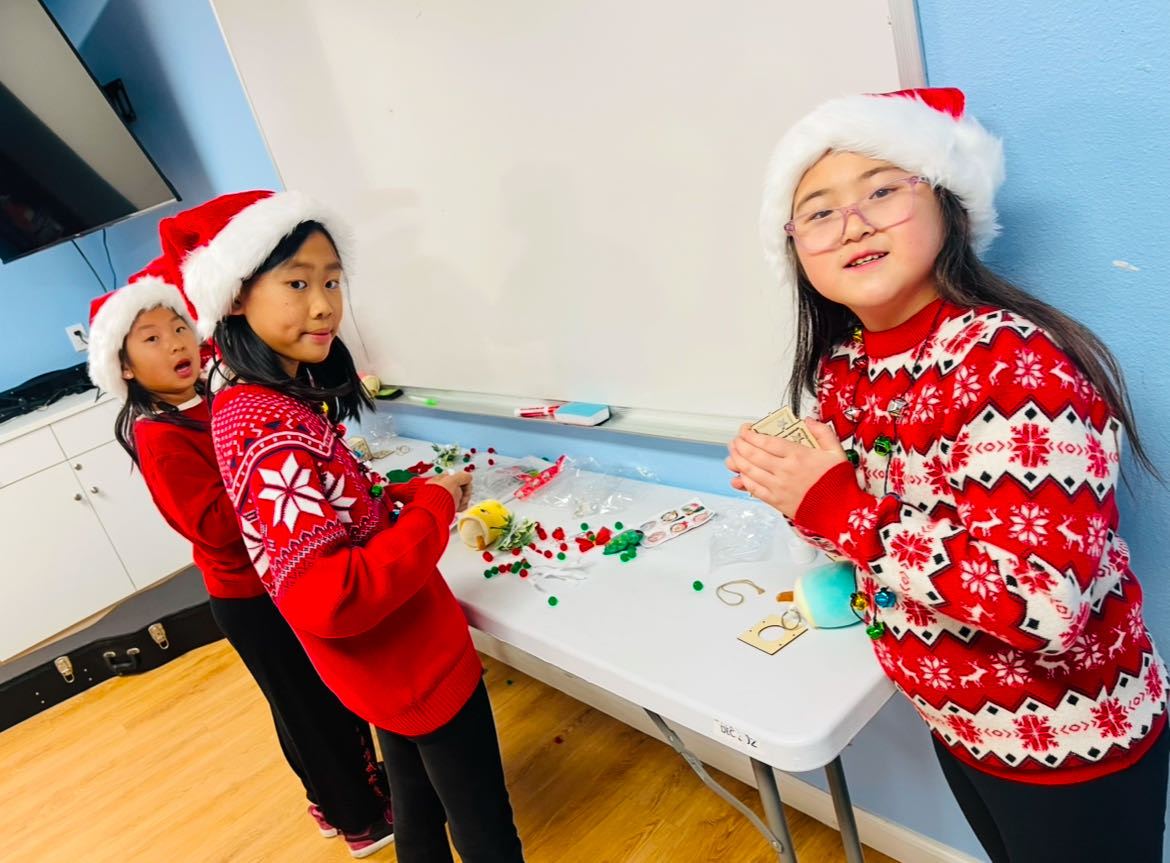 Kids making gingerbread houses in the craft room
