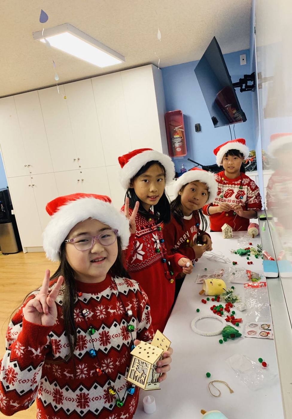 Kids holding up their finished crafts